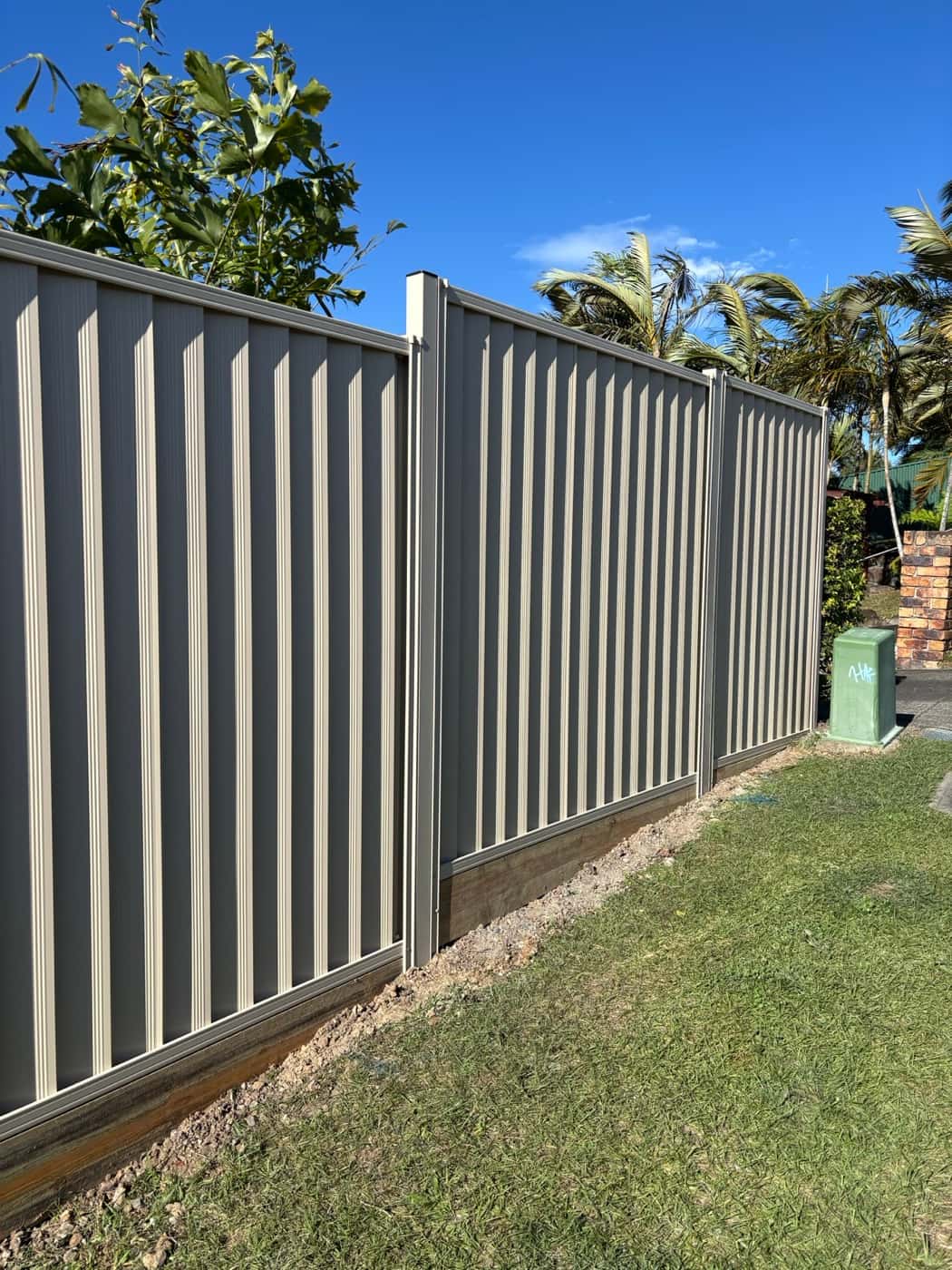 Grey Colorbond side fence with a plinth
