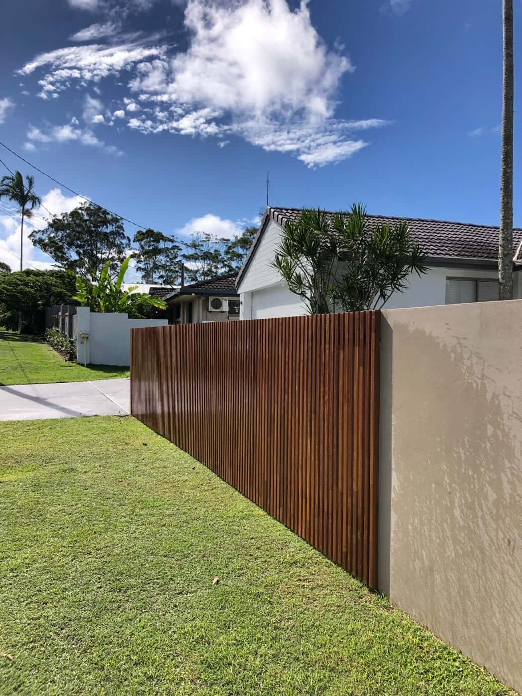 Vertical stained timber screen fence on a corner